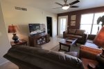 Spacious living room with flat screen TV and patio access